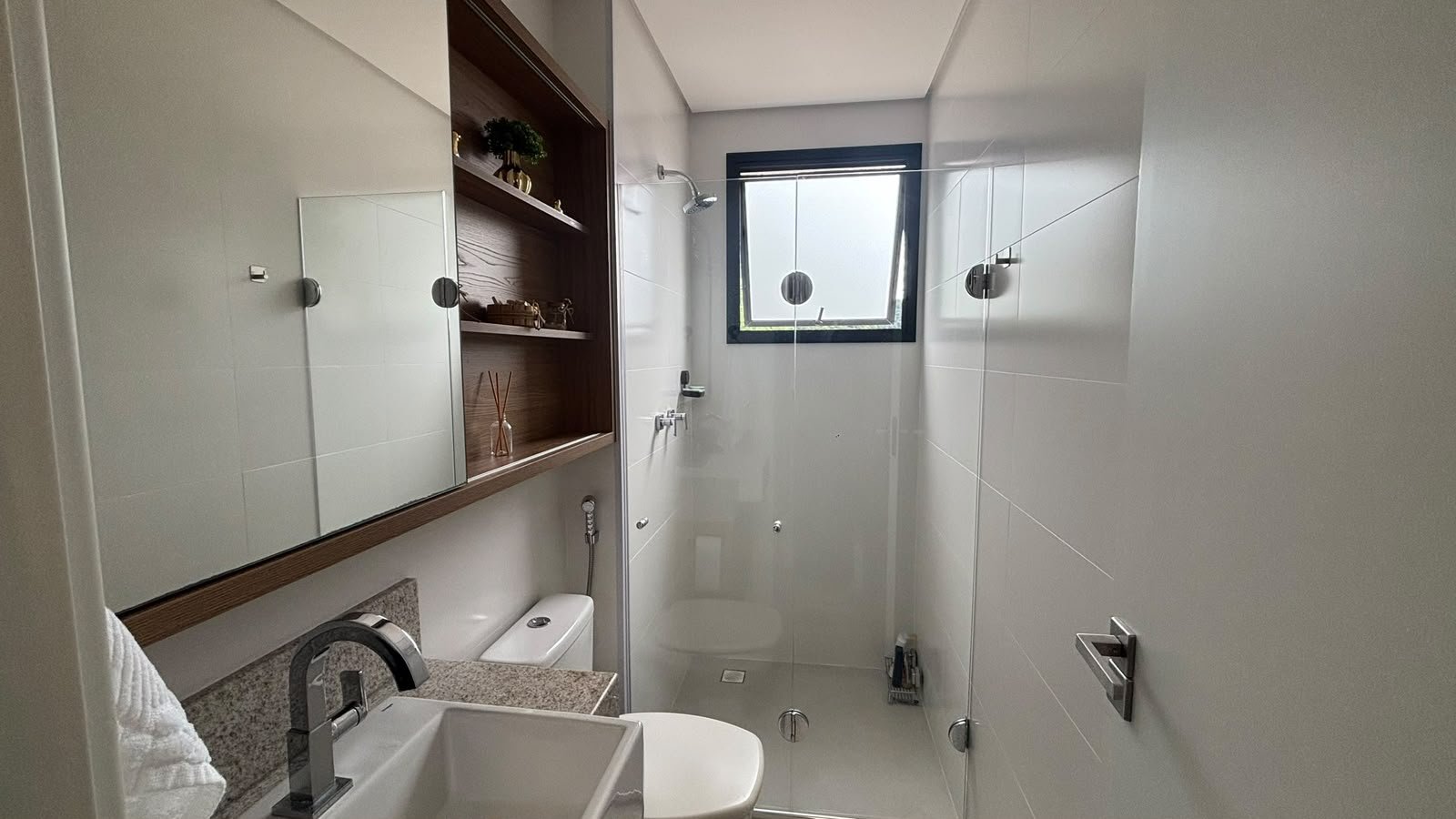 apartamento-praia-enseada-70-metros-mar (15) Banheiro da residência com bancada e espelho