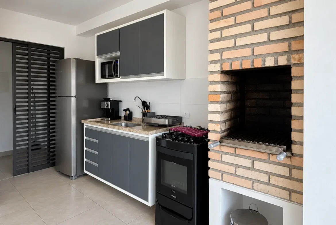 Varanda com churrasqueira do apartamento no Duo Itaguá