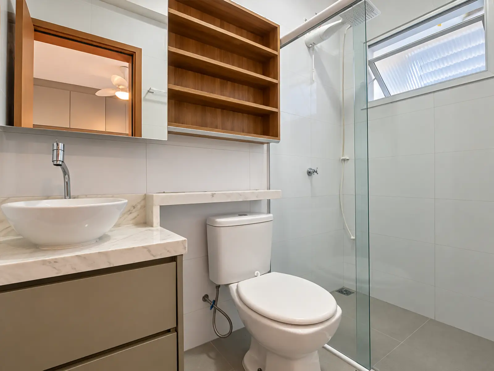 apartamento-itagua-ubatuba-90m2-banheiro Banheiro do apartamento com box de vidro e armário